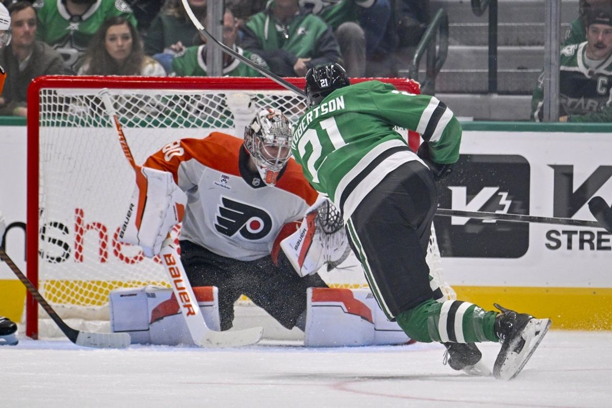 Nov 15, 2025; Dallas, Texas, USA; Dallas Stars left wing Jason Robertson (21) scores his third goal of the game against Philadelphia Flyers goaltender Dan Vladar (80) during the third period at the American Airlines Center. Mandatory Credit: Jerome Miron-Imagn Images