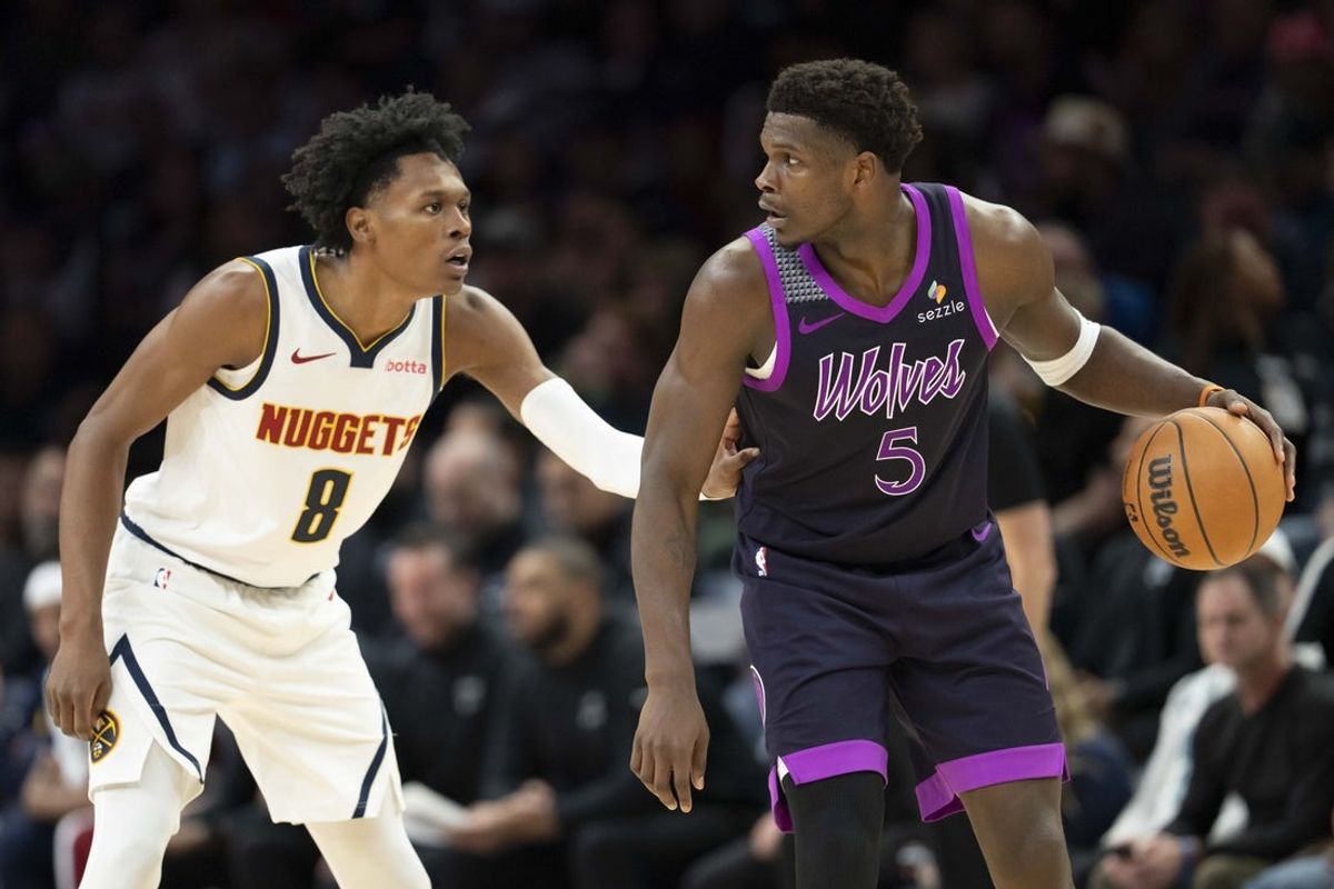 Nov 15, 2025; Minneapolis, Minnesota, USA; Minnesota Timberwolves guard Anthony Edwards (5) dribbles the Ball as Denver Nuggets guard Peyton Watson (8) plays defense in the second half at Target Center. Mandatory Credit: Jesse Johnson-Imagn Images