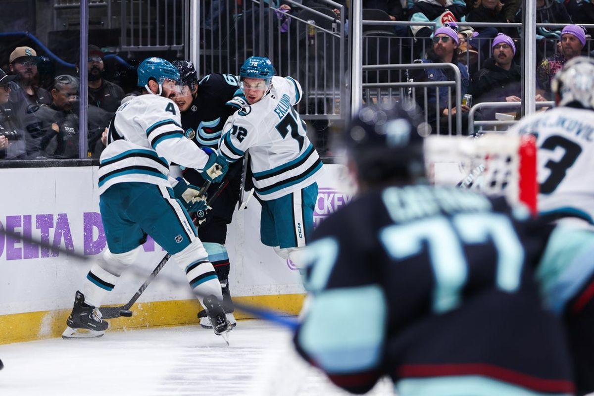 Nov 15, 2025; Seattle, Washington, USA; Seattle Kraken defenseman Brandon Montour (62) is pinched by San Jose Sharks left wing William Eklund (72) and defenseman Nick Leddy (4) in the first period at Climate Pledge Arena. Mandatory Credit: Kevin Ng-Imagn Images