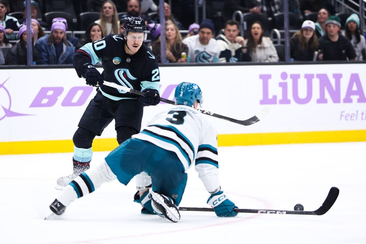 Nov 15, 2025; Seattle, Washington, USA; Seattle Kraken right wing Eeli Tolvanen (20) attempts to pass the puck while San Jose Sharks defenseman John Klingberg (3) defends in the third period at Climate Pledge Arena. Mandatory Credit: Kevin Ng-Imagn Images