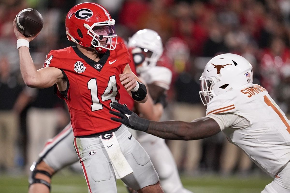 Nov 15, 2025; Athens, Georgia, USA; Georgia Bulldogs quarterback Gunner Stockton (14) attempts to make a pass under pressure by Texas Longhorns defensive end Colin Simmons (1) in the second half at Sanford Stadium. Mandatory Credit: Dale Zanine-Imagn Images