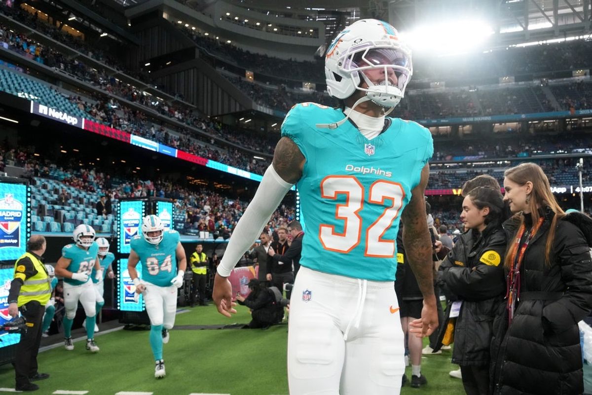 Nov 16, 2025; Madrid, Spain; Miami Dolphins cornerback JuJu Brents (32) runs onto the field prior to the 2025 NFL Madrid Game against the Washington Commanders at Santiago Bernabeu Stadium. Mandatory Credit: Kirby Lee-Imagn Images