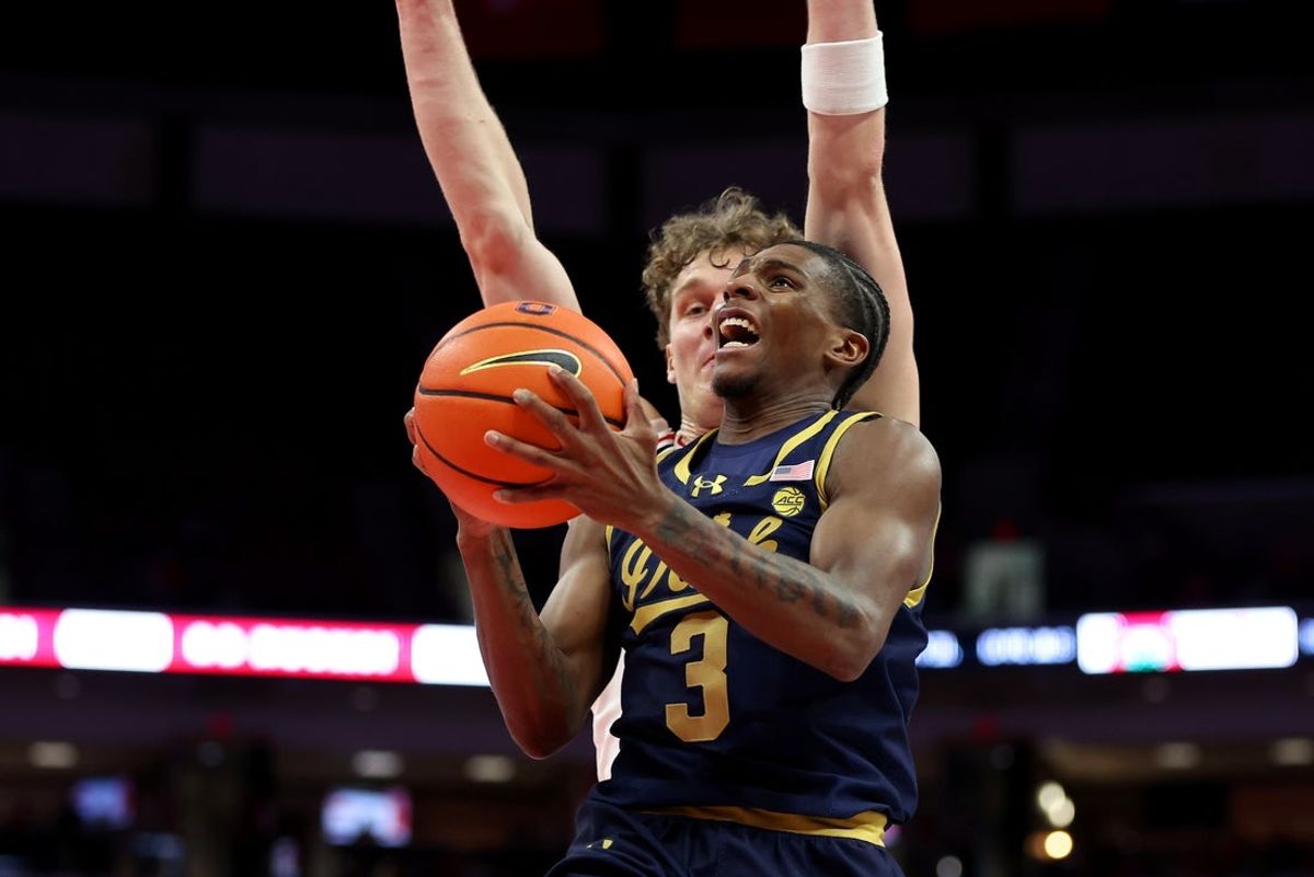 Nov 16, 2025; Columbus, Ohio, USA; Notre Dame Fighting Irish guard Markus Burton (3) goes to the basket as Ohio State Buckeyes center Christoph Tilly (13) defends during the first half at Value City Arena. Mandatory Credit: Joseph Maiorana-Imagn Images