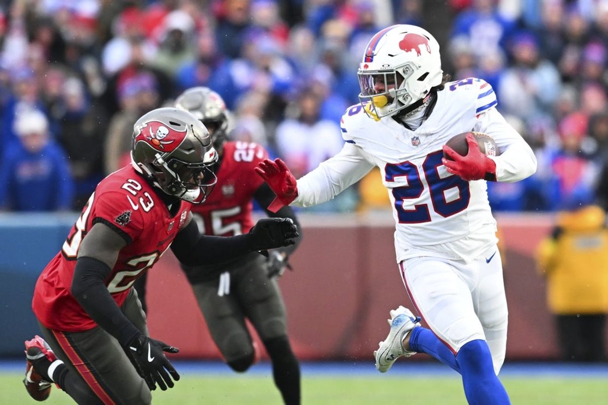 Nov 16, 2025; Orchard Park, New York, USA;  Buffalo Bills running back Ty Johnson (26) runs for a touchdown against the Tampa Bay Buccaneers during the first half of the game at Highmark Stadium. Mandatory Credit: Mark Konezny-Imagn Images