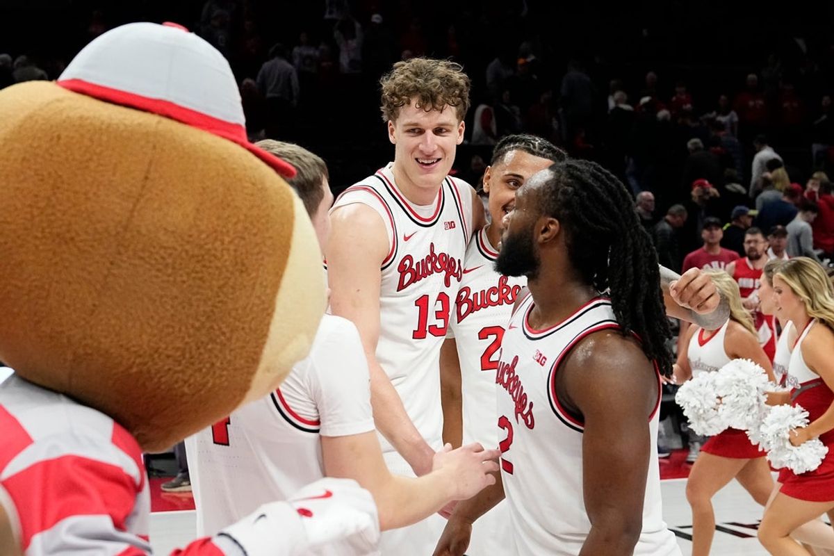 Ohio State Buckeyes center Christoph Tilly (13) celebrates with teammates following the men's NCAA basketball game against the Notre Dame Fighting Irish at Value City Arena in Columbus on Nov. 16, 2025. Tilly hit the game-winning shot in the 64-63 Buckeyes win.