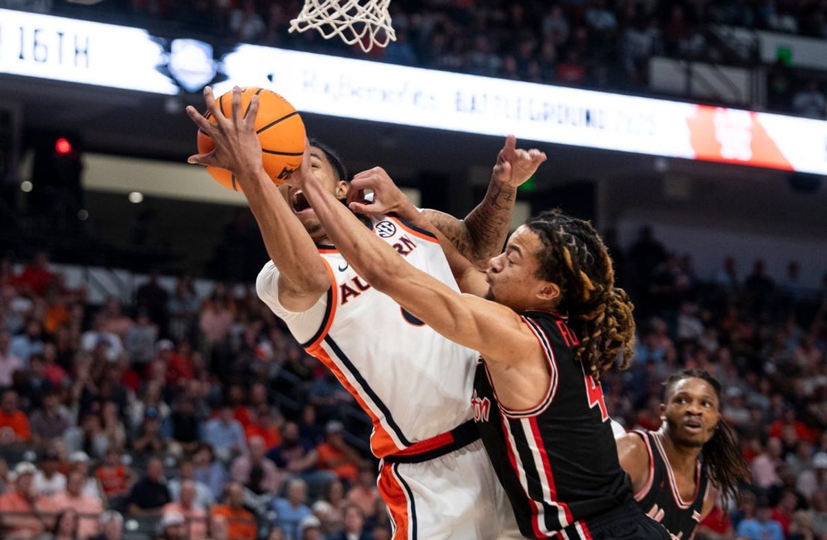 Auburn Tigers guard Elyjah Freeman (6) and Houston Cougars guard Kingston Flemings (4) fight for a rebound as Auburn Tigers take on the Houston Cougars at Legacy Arena in Birmingham, Ala. on Sunday, Nov. 16, 2025.