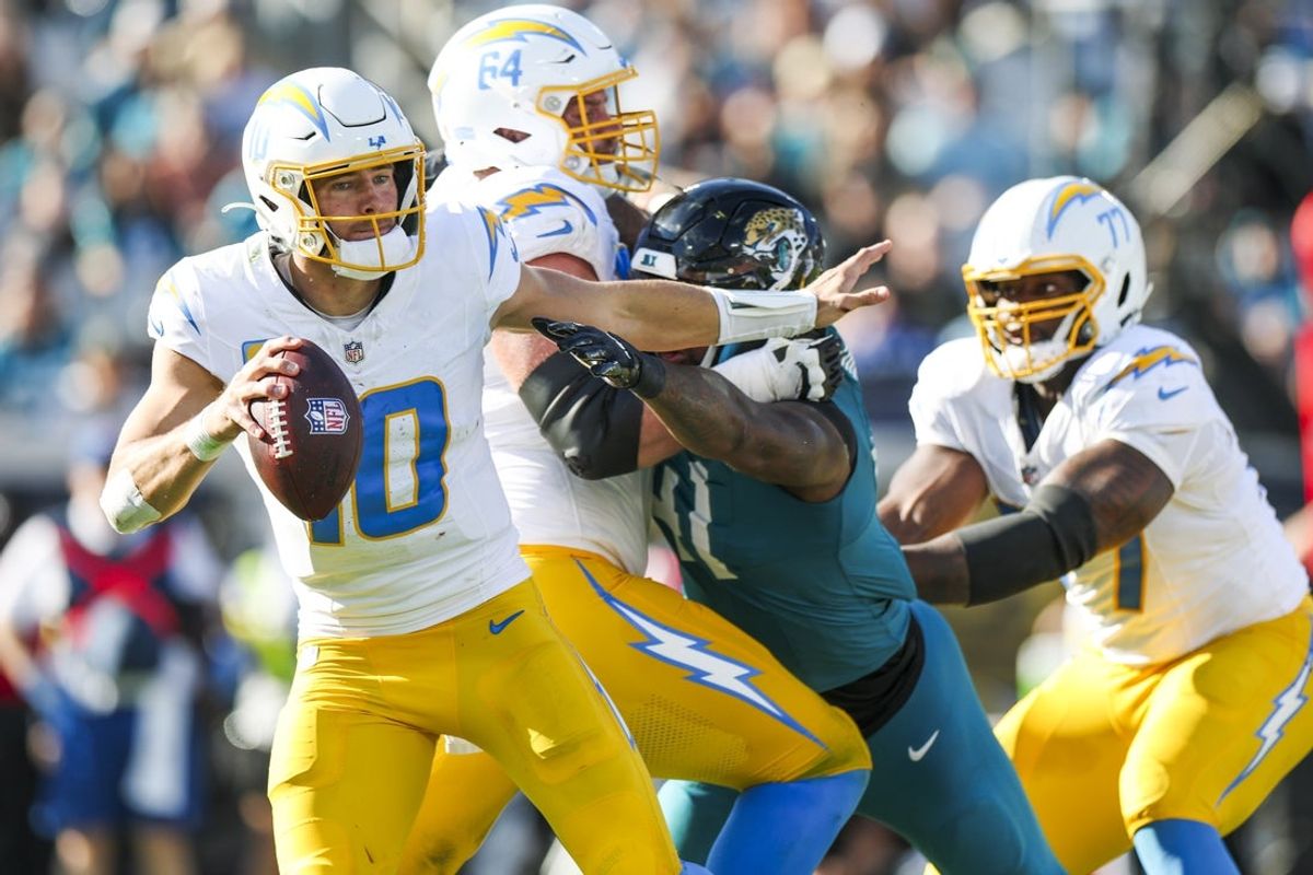 Nov 16, 2025; Jacksonville, Florida, USA; Los Angeles Chargers quarterback Justin Herbert (10) looks to pass while under pressure against the Jacksonville Jaguars during the third quarter at EverBank Stadium. Mandatory Credit: Nathan Ray Seebeck-Imagn Images