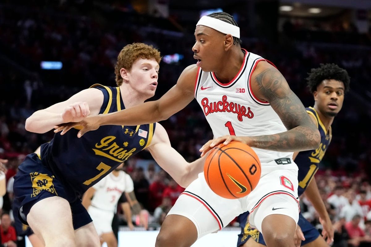Ohio State Buckeyes forward Amare Bynum (1) dribbles around Notre Dame Fighting Irish forward Ryder Frost (7) during the men's NCAA basketball game at Value City Arena in Columbus on Nov. 16, 2025. Ohio State won 64-63.