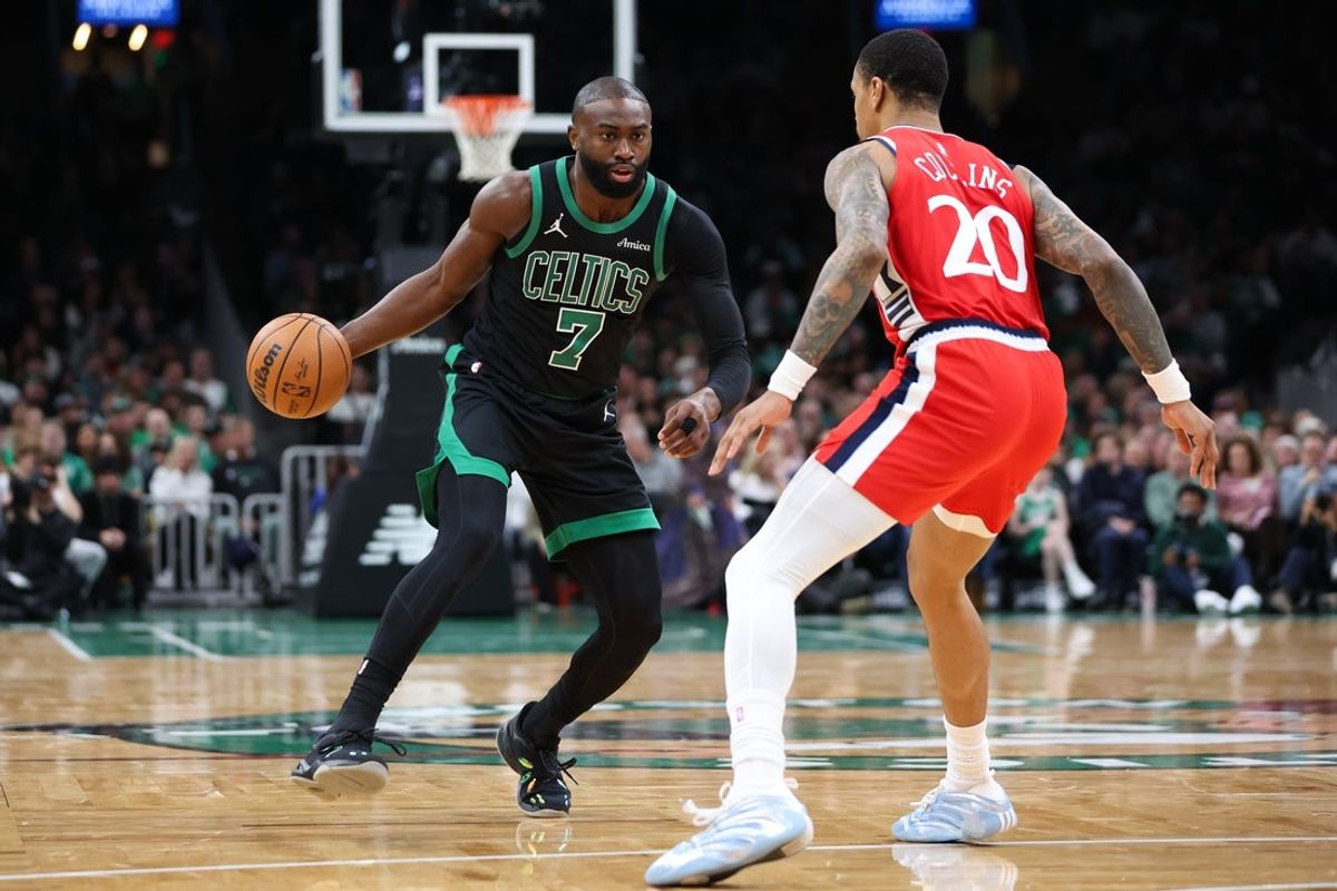 Nov 16, 2025; Boston, Massachusetts, USA; Boston Celtics forward Jaylen Brown (7) dribbles down the court defended by Los Angeles Clippers center John Collins (20) during the first half at TD Garden. Mandatory Credit: Paul Rutherford-Imagn Images