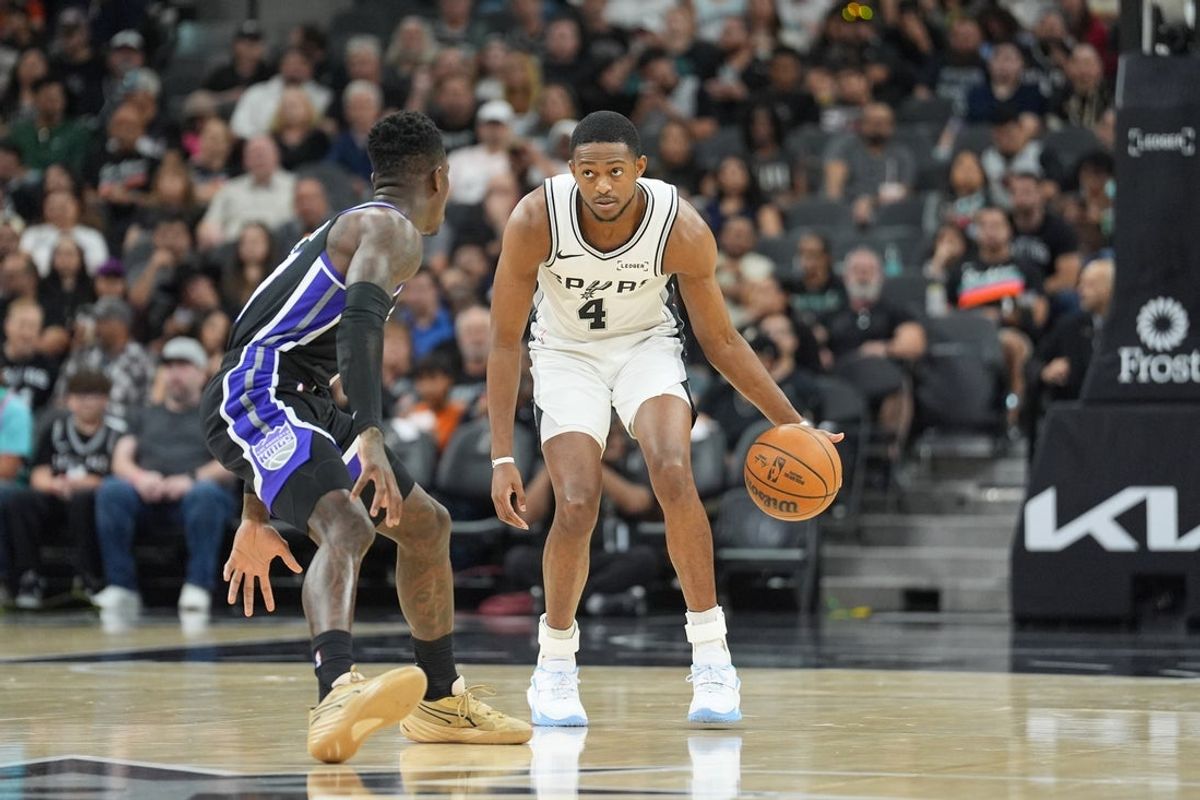 Nov 16, 2025; San Antonio, Texas, USA; San Antonio Spurs guard De'Aaron Fox (4) dribbles in front of Sacramento Kings guard Dennis Schroder (17) in the first half at Frost Bank Center. Mandatory Credit: Daniel Dunn-Imagn Images