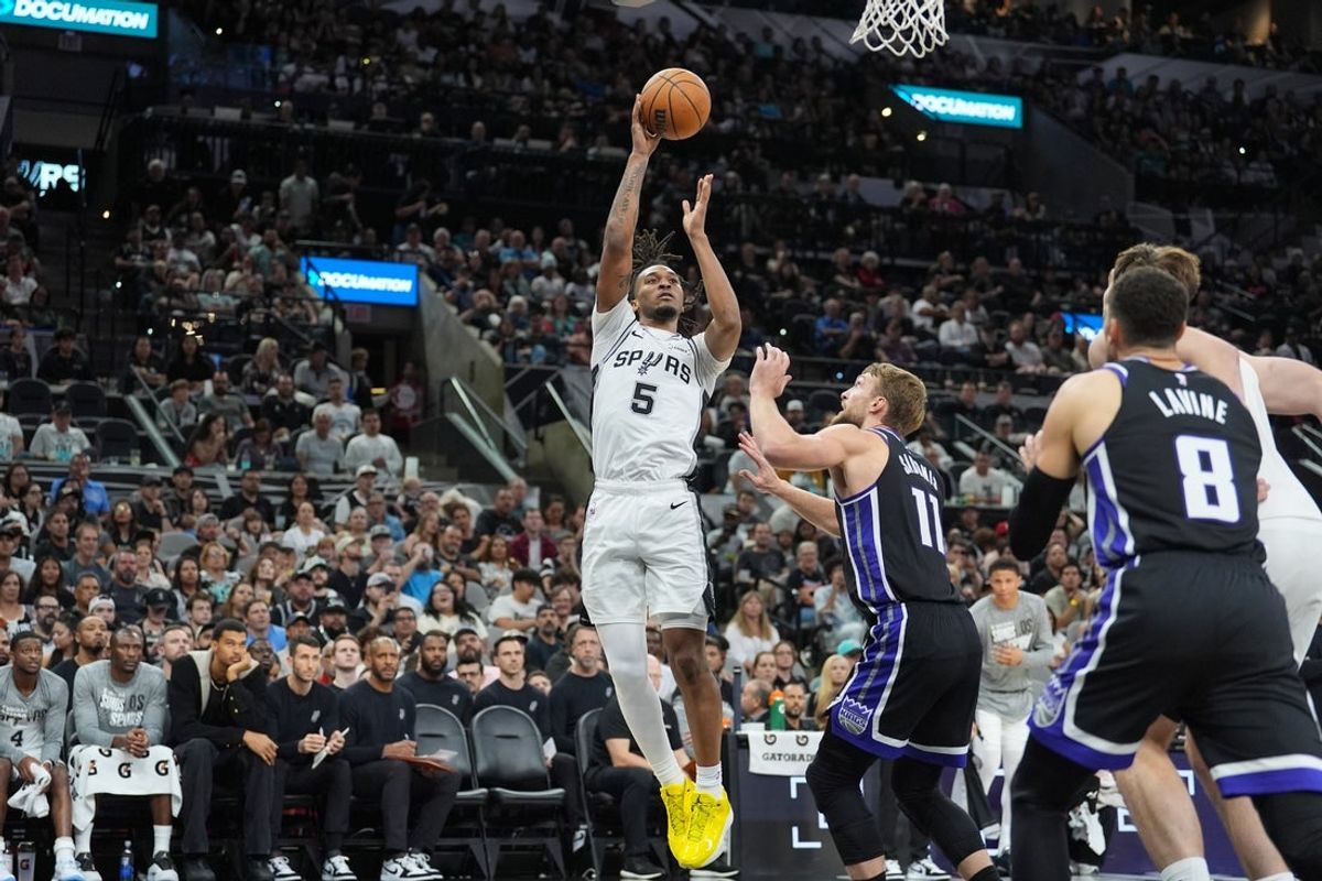 Nov 16, 2025; San Antonio, Texas, USA; San Antonio Spurs guard Stephon Castle (5) in front of Sacramento Kings forward Domantas Sabonis (11) in the first half at Frost Bank Center. Mandatory Credit: Daniel Dunn-Imagn Images