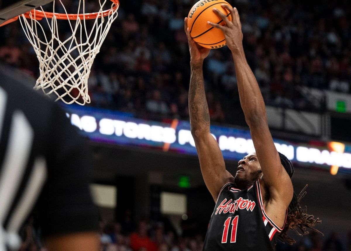 Houston Cougars forward Joseph Tugler (11) dunks the ball as Auburn Tigers take on the Houston Cougars at Legacy Arena in Birmingham, Ala. on Sunday, Nov. 16, 2025. Houston Cougars defeated Auburn Tigers 73-72.