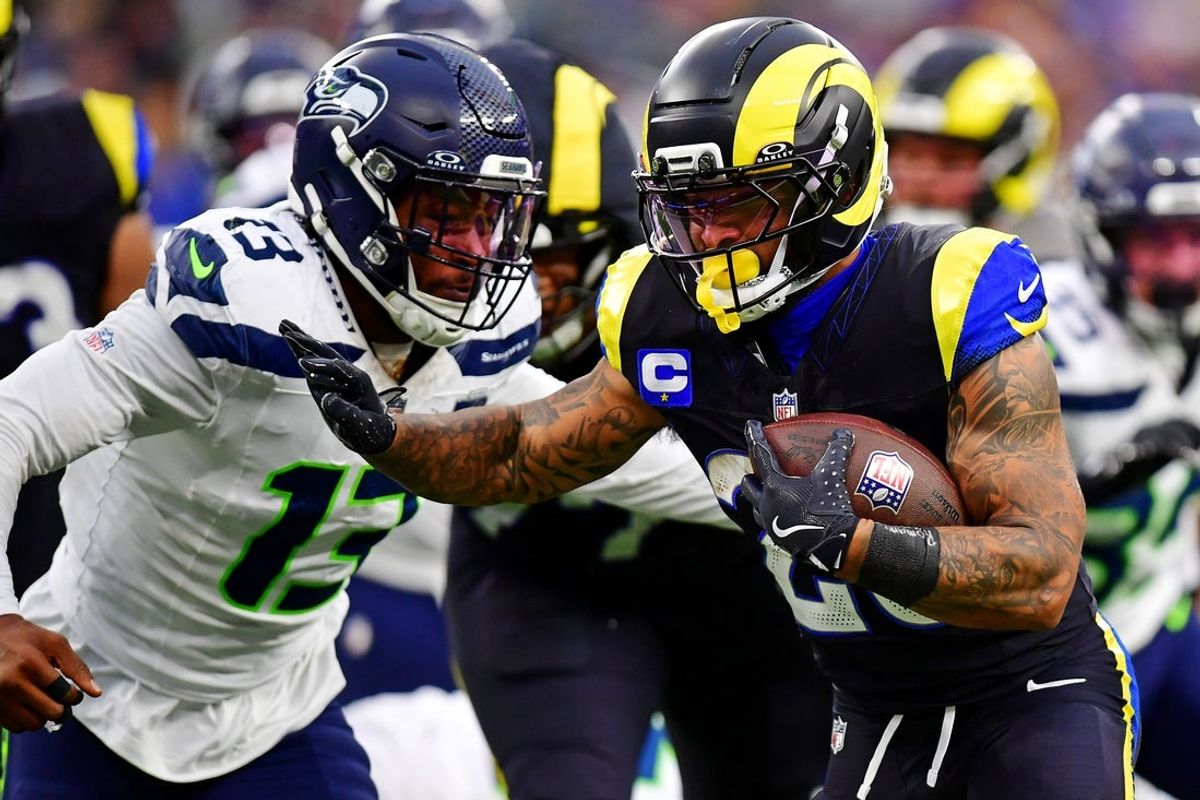 Nov 16, 2025; Inglewood, California, USA; Los Angeles Rams running back Kyren Williams (23) against Seattle Seahawks linebacker Ernest Jones IV (13) during the second half at SoFi Stadium. Mandatory Credit: Gary A. Vasquez-Imagn Images