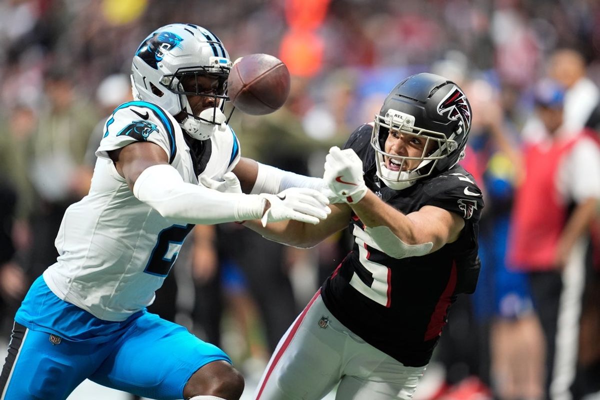 Nov 16, 2025; Atlanta, Georgia, USA; Carolina Panthers cornerback Mike Jackson (2) and Atlanta Falcons wide receiver Drake London (5) battle for the ball in the second half at Mercedes-Benz Stadium. Mandatory Credit: Dale Zanine-Imagn Images