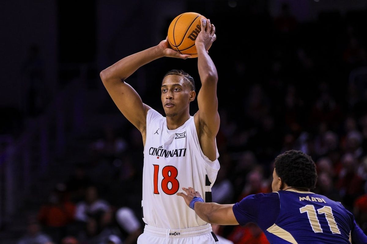 Nov 16, 2025; Cincinnati, Ohio, USA; Cincinnati Bearcats forward Baba Miller (18) holds the ball against Mount St. Mary's Mountaineers forward Justin Amadi (11) in the first half at Fifth Third Arena. Mandatory Credit: Katie Stratman-Imagn Images