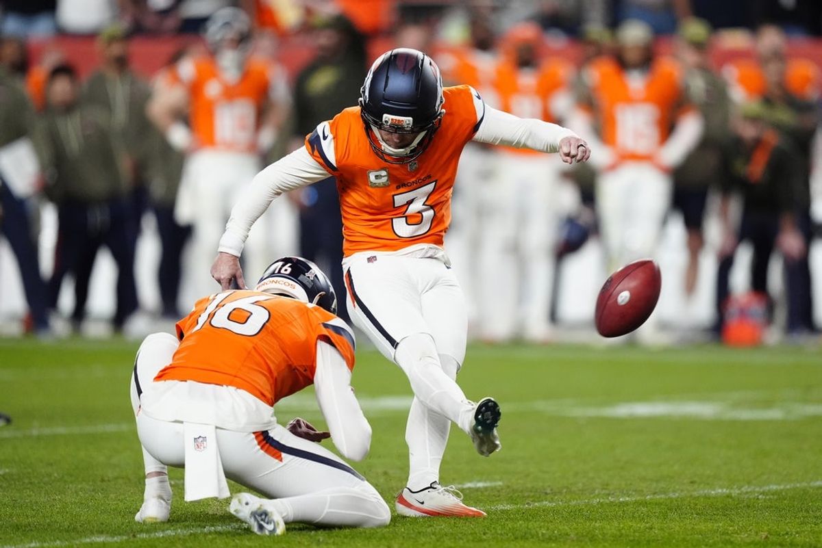 Nov 16, 2025; Denver, Colorado, USA; Denver Broncos kicker Wil Lutz (3) kicks the game winning field goal as punter Jeremy Crawshaw (16) assists in the fourth quarter against the Kansas City Chiefs at Empower Field at Mile High. Mandatory Credit: Ron Chenoy-Imagn Images