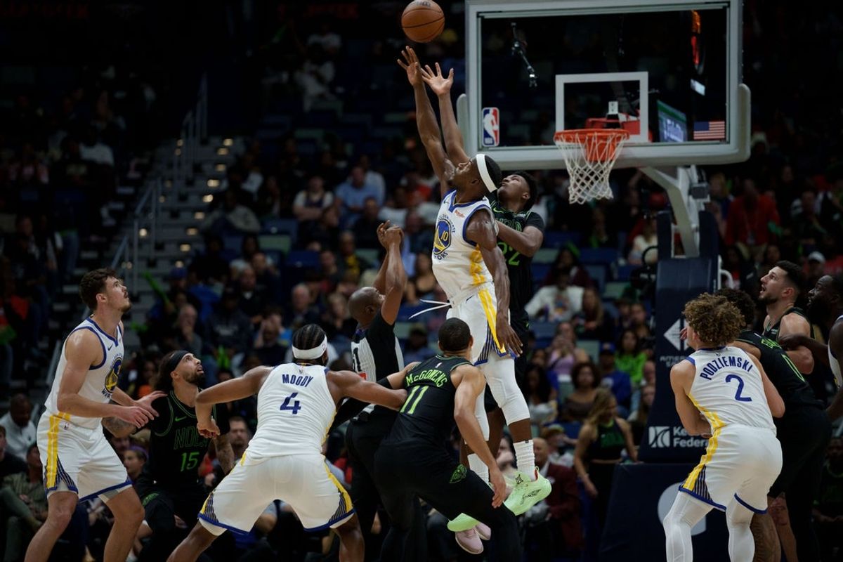 Nov 16, 2025; New Orleans, Louisiana, USA; Golden State Warriors forward Jimmy Butler III (10) jumps for a ball next to New Orleans Pelicans center Derik Queen (22) during the first half at Smoothie King Center. Mandatory Credit: Matthew Hinton-Imagn Images