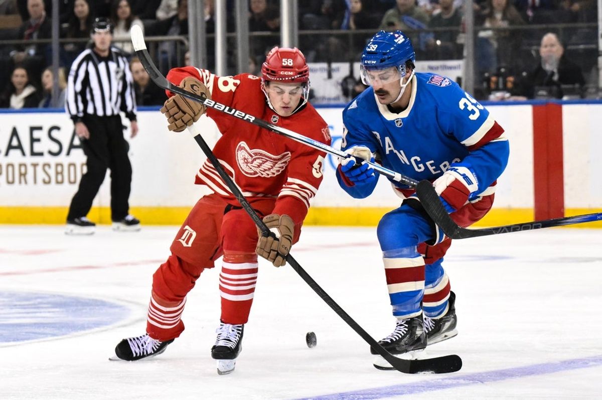 Nov 16, 2025; New York, New York, USA; Detroit Red Wings center Emmitt Finnie (58) and New York Rangers center Sam Carrick (39) compete for the puck during the second period at Madison Square Garden. Mandatory Credit: John Jones-Imagn Images