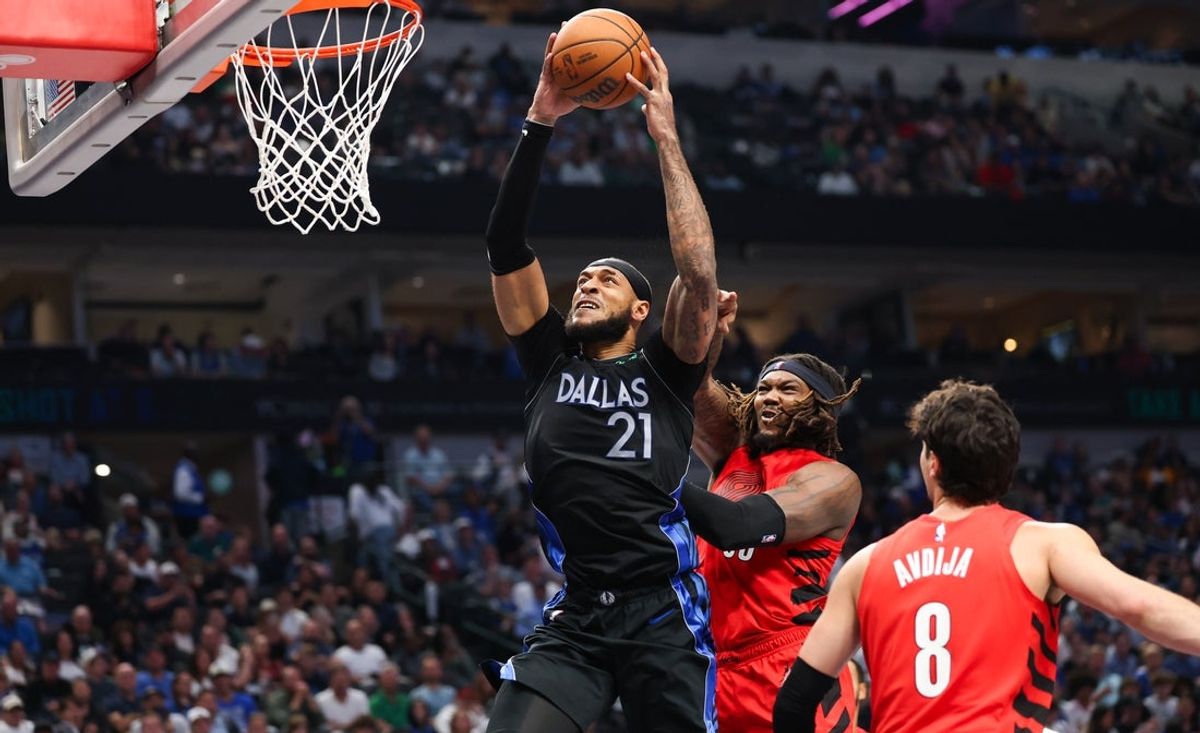 Nov 16, 2025; Dallas, Texas, USA;  Dallas Mavericks forward Daniel Gafford (21) scores past Portland Trail Blazers center Robert Williams III (35) during the second quarter at American Airlines Center. Mandatory Credit: Kevin Jairaj-Imagn Images