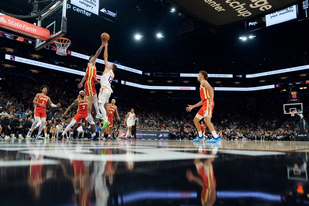 Nov 16, 2025; Phoenix, Arizona, USA; Atlanta Hawks guard Vit Krejci (27) reaches out and blocks Phoenix Suns guard Collin Gillespie (12) during the first half of a game at Mortgage Matchup Center. Mandatory Credit: Allan Henry-Imagn Images
