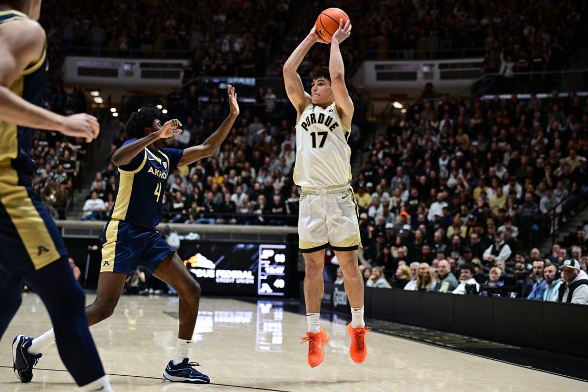 Nov 16, 2025; West Lafayette, Indiana, USA; Purdue Boilermakers guard Omer Mayer (17) passes the ball away from Akron Zips guard Eric Mahaffey (4) during the second half at Mackey Arena. Mandatory Credit: Marc Lebryk-Imagn Images