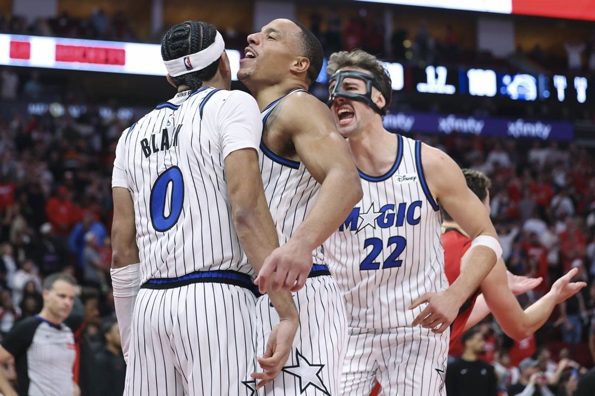 Nov 16, 2025; Houston, Texas, USA; Orlando Magic guard Desmond Bane (3) and forward Franz Wagner (22) celebrate with guard Anthony Black (0) after Black makes a basket during the fourth quarter against the Houston Rockets at Toyota Center. Mandatory Credit: Troy Taormina-Imagn Images