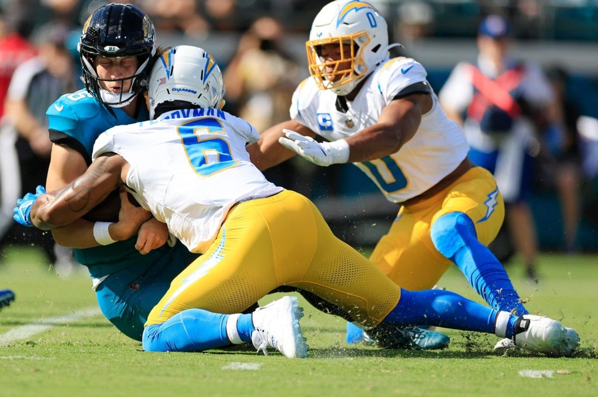 Jacksonville Jaguars quarterback Trevor Lawrence (16) slides down as no penalty is called on Los Angeles Chargers middle linebacker Denzel Perryman (6) during the first quarter of an NFL football game at EverBank Stadium, Sunday, Nov. 16, 2025 in Jacksonville, Fla. The Jacksonville Jaguars defeated the Los Angeles Chargers 35-6. [Corey Perrine/Florida Times-Union]
