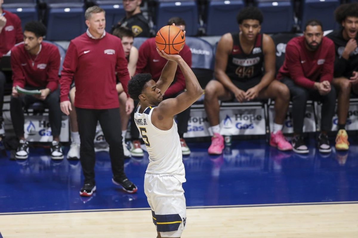Nov 17, 2025; Morgantown, West Virginia, USA; West Virginia Mountaineers forward DJ Thomas (5) shoots a three-point shot during the first half against the Lafayette Leopards at WVU Coliseum. Mandatory Credit: Ben Queen-Imagn Images