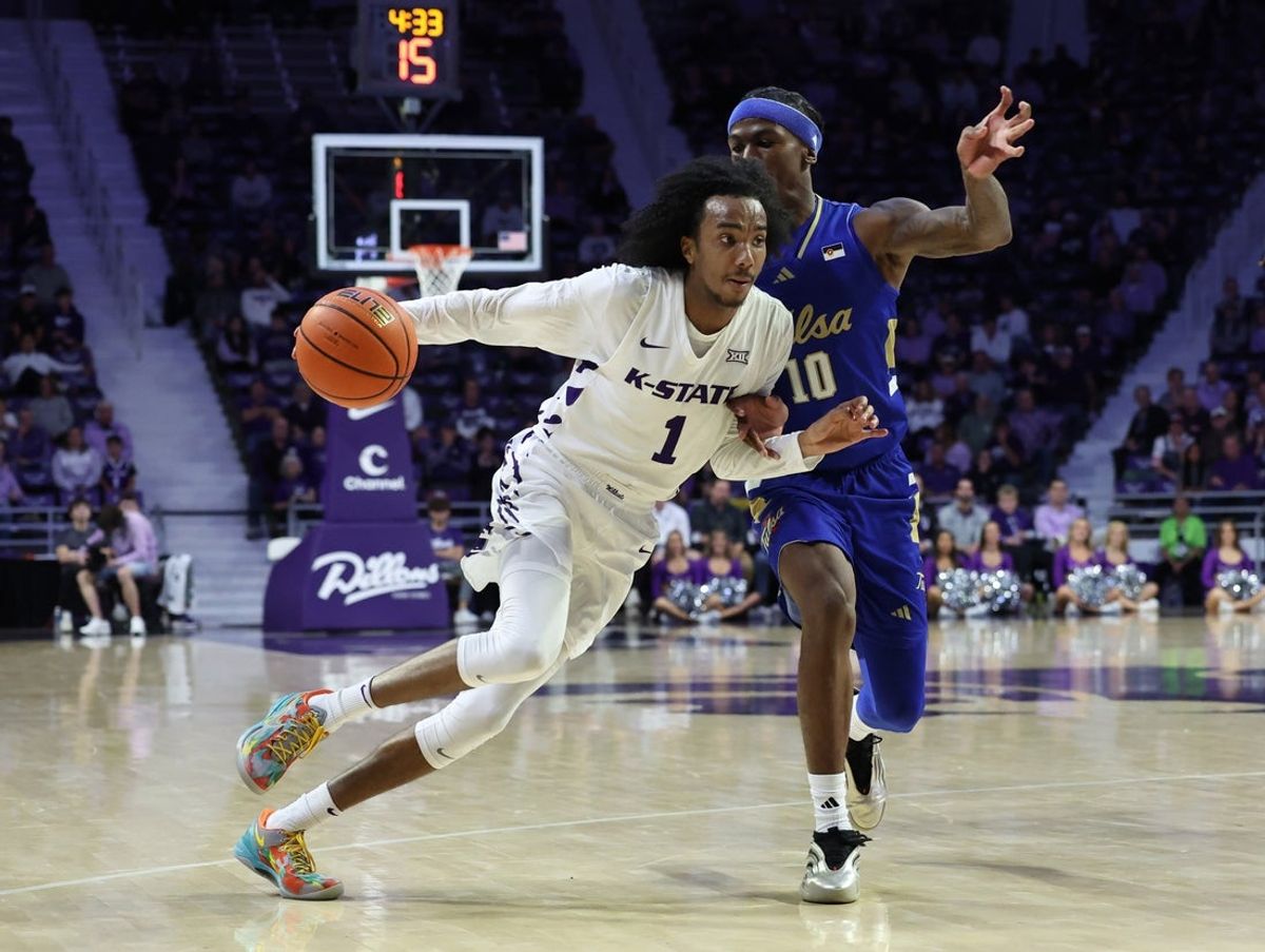 Nov 17, 2025; Manhattan, Kansas, USA; Kansas State Wildcats guard Abdi Bashir Jr. (1) dribbles against Tulsa Golden Hurricane guard Tylen Riley (10) during the first half at Bramlage Coliseum. Mandatory Credit: Scott Sewell-Imagn Images
