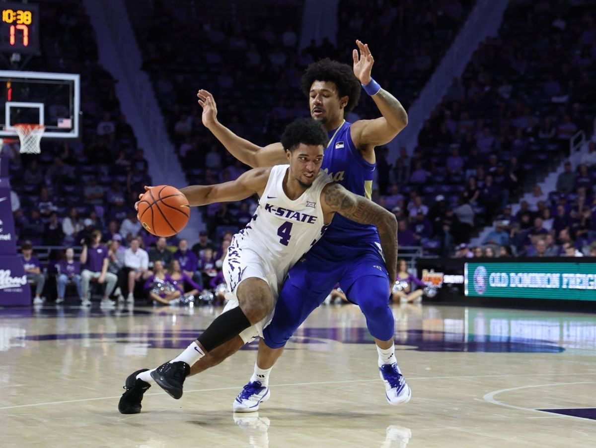 Nov 17, 2025; Manhattan, Kansas, USA; Kansas State Wildcats guard P.J. Haggerty (4) is guarded by Tulsa Golden Hurricane guard Jaylen Lawal (2) during the first half at Bramlage Coliseum. Mandatory Credit: Scott Sewell-Imagn Images