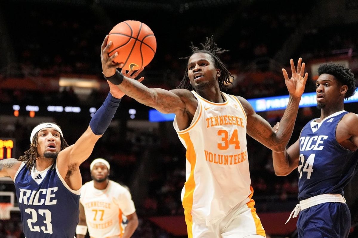 Tennessee forward Felix Okpara (34) and Rice guard/forward Nick Anderson (23) go after the rebound during an NCAA college basketball game on November 17, 2025, in Knoxville, Tenn.