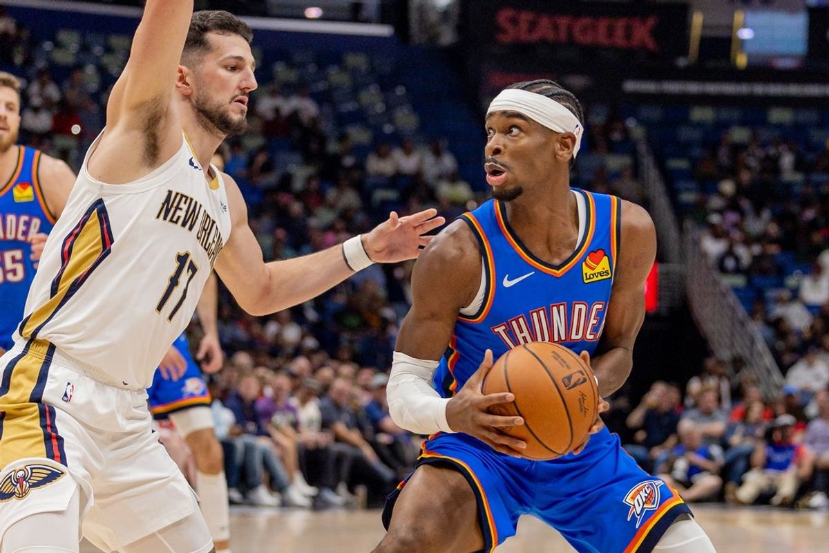 Nov 17, 2025; New Orleans, Louisiana, USA;  during the first half at Smoothie King Center. Oklahoma City Thunder guard Shai Gilgeous-Alexander (2) dribbles against New Orleans Pelicans forward/center Karlo Matkovic (17) Mandatory Credit: Stephen Lew-Imagn Images