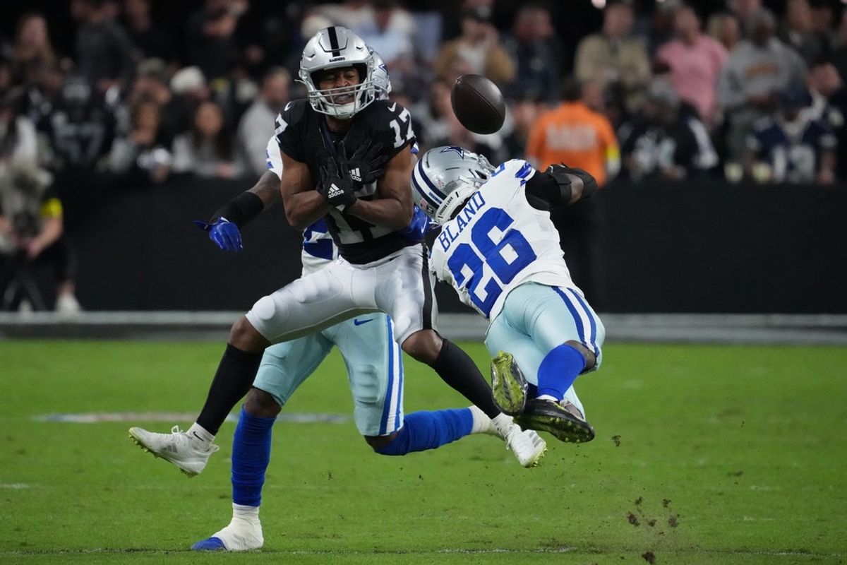 Nov 17, 2025; Paradise, Nevada, USA; Dallas Cowboys cornerback Caelen Carson (21) and cornerback DaRon Bland (26) break up the pass attempt to Las Vegas Raiders wide receiver Tyler Lockett (17) during the first half at Allegiant Stadium. Mandatory Credit: Kirby Lee-Imagn Images