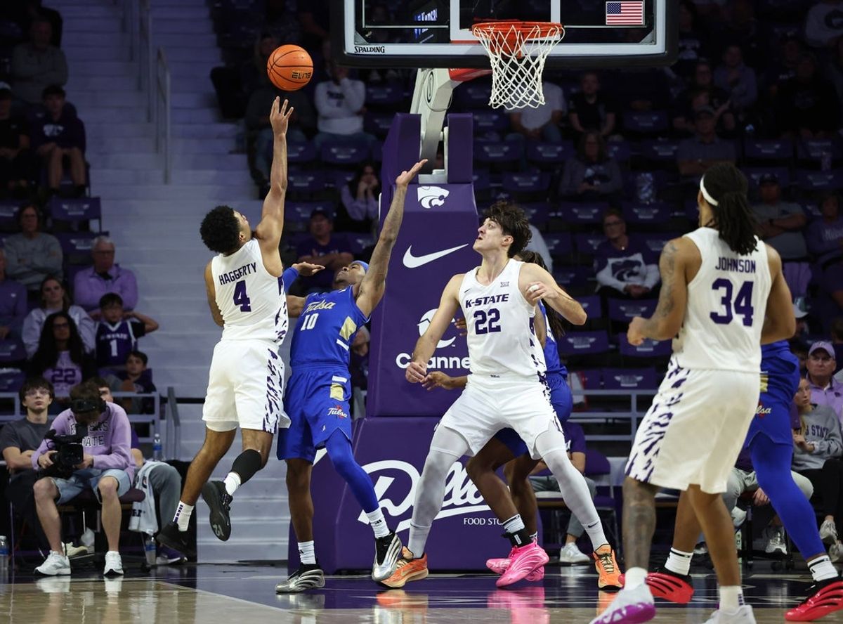 Nov 17, 2025; Manhattan, Kansas, USA; Kansas State Wildcats guard P.J. Haggerty (4) shoots against Tulsa Golden Hurricane guard Tylen Riley (10) during the second half at Bramlage Coliseum. Mandatory Credit: Scott Sewell-Imagn Images
