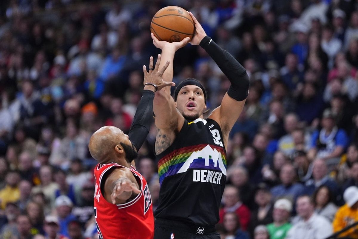 Nov 17, 2025; Denver, Colorado, USA; Denver Nuggets forward Aaron Gordon (32) shoots over Chicago Bulls guard Jevon Carter (5) in the second half at Ball Arena. Mandatory Credit: Ron Chenoy-Imagn Images
