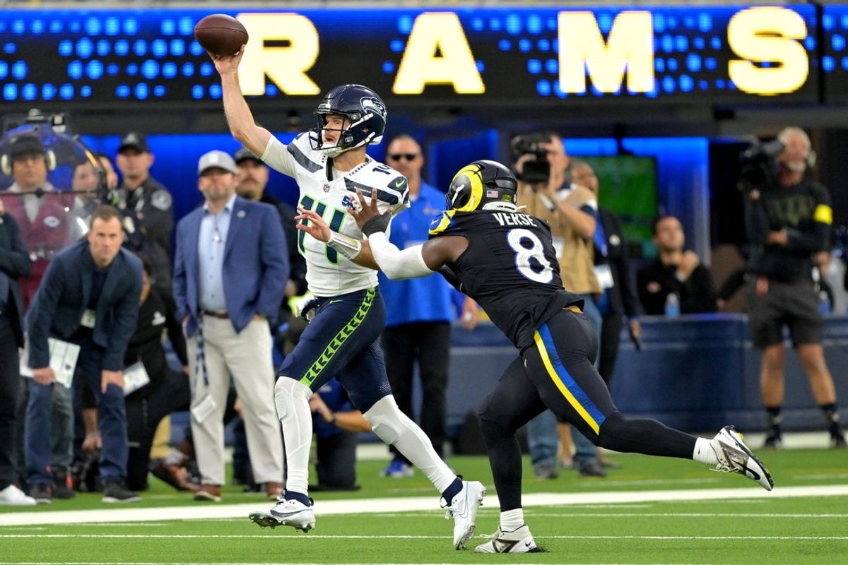 Nov 16, 2025; Inglewood, California, USA;  Seattle Seahawks quarterback Sam Darnold (14) is pressured by Los Angeles Rams linebacker Jared Verse (8) at SoFi Stadium. Mandatory Credit: Jayne Kamin-Oncea-Imagn Images