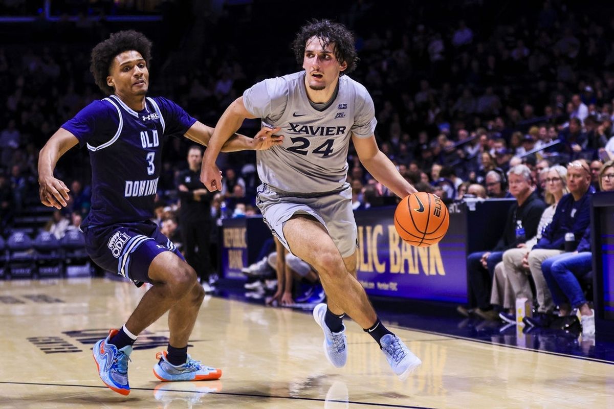 Nov 18, 2025; Cincinnati, Ohio, USA; Xavier Musketeers forward Jovan Milicevic (24) dribbles against Old Dominion Monarchs guard Scottie Hubbard (3) in the first half at Cintas Center. Mandatory Credit: Katie Stratman-Imagn Images