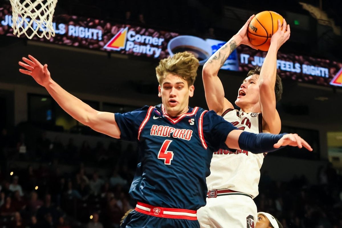 Nov 18, 2025; Columbia, South Carolina, USA; South Carolina Gamecocks guard Mike Sharavjamts (55) shoots over Radford Highlanders guard Brennan Rigsby (4) in the first half at Colonial Life Arena. Mandatory Credit: Jeff Blake-Imagn Images