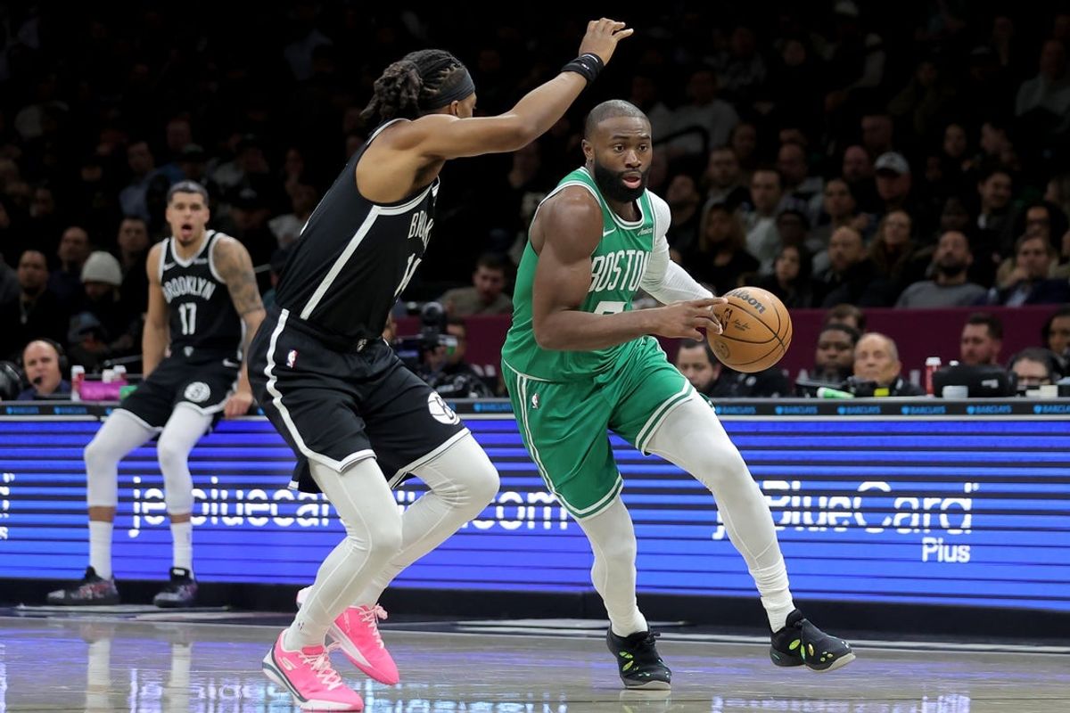 Nov 18, 2025; Brooklyn, New York, USA; Boston Celtics guard Jaylen Brown (7) brings the ball up court against Brooklyn Nets guard Terance Mann (14) during the second quarter at Barclays Center. Mandatory Credit: Brad Penner-Imagn Images
