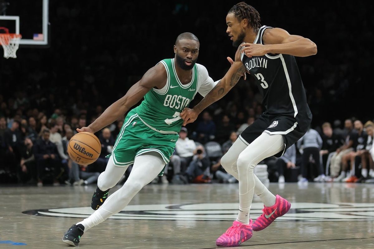 Nov 18, 2025; Brooklyn, New York, USA; Boston Celtics guard Jaylen Brown (7) brings the ball up court against Brooklyn Nets center Nic Claxton (33) during the second quarter at Barclays Center. Mandatory Credit: Brad Penner-Imagn Images