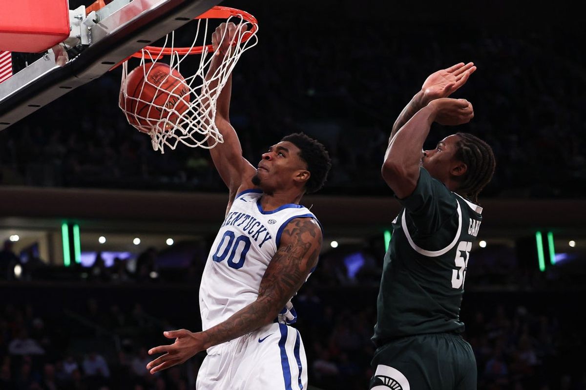 Nov 18, 2025; New York, New York, USA; Kentucky Wildcats guard Otega Oweh (00) dunks in front of Michigan State Spartans forward Coen Carr (55) during the second half at Madison Square Garden. Mandatory Credit: Vincent Carchietta-Imagn Images