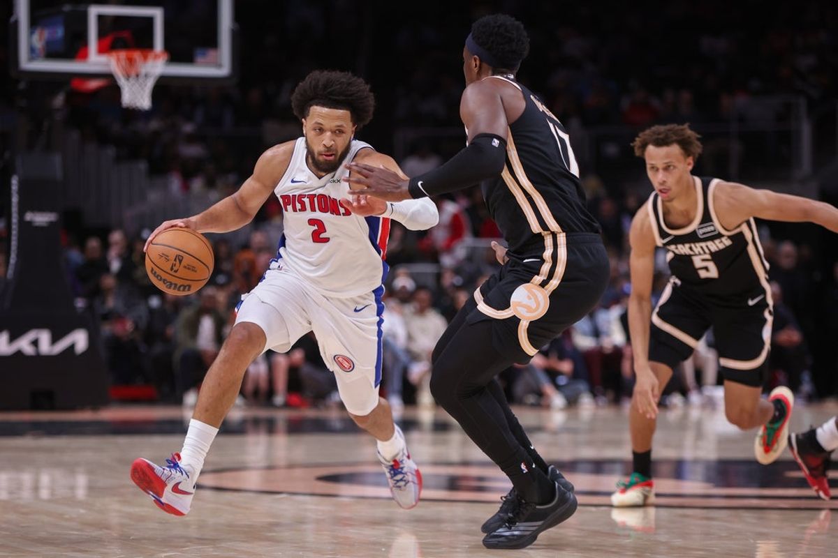 Nov 18, 2025; Atlanta, Georgia, USA; Detroit Pistons guard Cade Cunningham (2) drives on Atlanta Hawks forward Onyeka Okongwu (17) in the second quarter at State Farm Arena. Mandatory Credit: Brett Davis-Imagn Images
