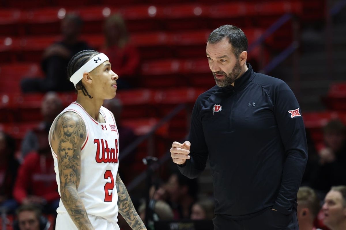 Nov 18, 2025; Salt Lake City, Utah, USA; Utah Utes guard Terrence Brown (2) speaks with head coach Alex Jensen during the first half of a game against the Purdue Fort Wayne Mastodons at Jon M. Huntsman Center. Mandatory Credit: Rob Gray-Imagn Images