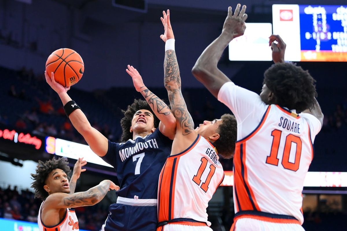 Nov 18, 2025; Syracuse, New York, USA; Monmouth Hawks guard Justin Ray (7) drives for a shot as Syracuse Orange guard Naithan George (11) and forward Ibrahim Souare (10) defend during the first half at the JMA Wireless Dome. Mandatory Credit: Rich Barnes-Imagn Images