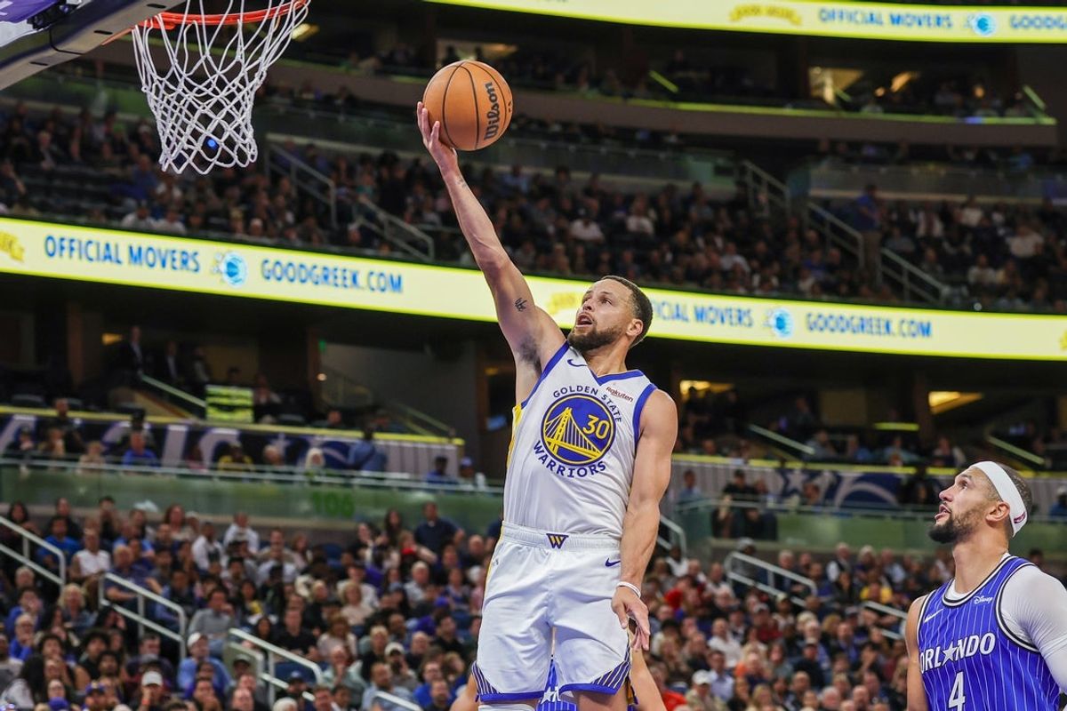 Nov 18, 2025; Orlando, Florida, USA; Golden State Warriors guard Stephen Curry (30) lays up during the second half against the Orlando Magic at Kia Center. Mandatory Credit: Mike Watters-Imagn Images