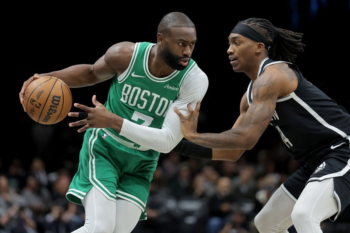Nov 18, 2025; Brooklyn, New York, USA; Boston Celtics guard Jaylen Brown (7) controls the ball against Brooklyn Nets guard Terance Mann (14) during the first quarter at Barclays Center. Mandatory Credit: Brad Penner-Imagn Images