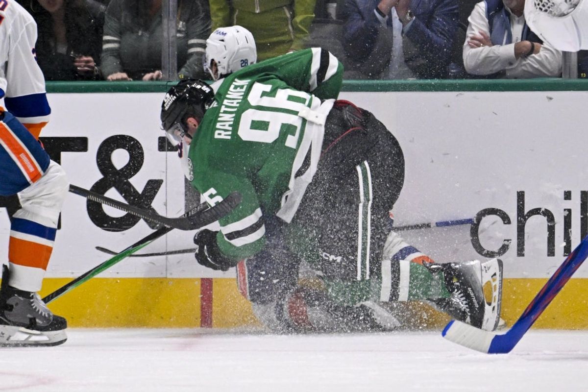 Nov 18, 2025; Dallas, Texas, USA; Dallas Stars right wing Mikko Rantanen (96) is called for a game misconduct penalty for boarding on New York Islanders defenseman Alexander Romanov (28) during the third period at the American Airlines Center. Mandatory Credit: Jerome Miron-Imagn Images