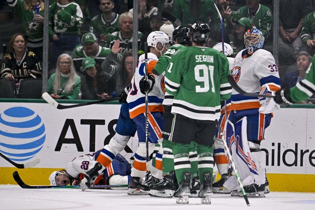Nov 18, 2025; Dallas, Texas, USA; Dallas Stars right wing Mikko Rantanen (96) is called for a game misconduct penalty for boarding on New York Islanders defenseman Alexander Romanov (28) during the third period at the American Airlines Center. Mandatory Credit: Jerome Miron-Imagn Images