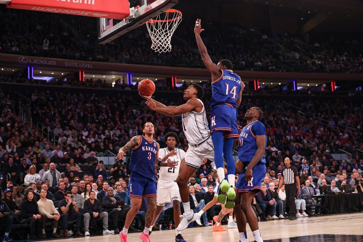 Nov 18, 2025; New York, New York, USA; Duke Blue Devils guard Caleb Foster (1) goes to the basket as Kansas Jayhawks guard Melvin Council Jr. (14) defends during the second half at Madison Square Garden. Mandatory Credit: Vincent Carchietta-Imagn Images