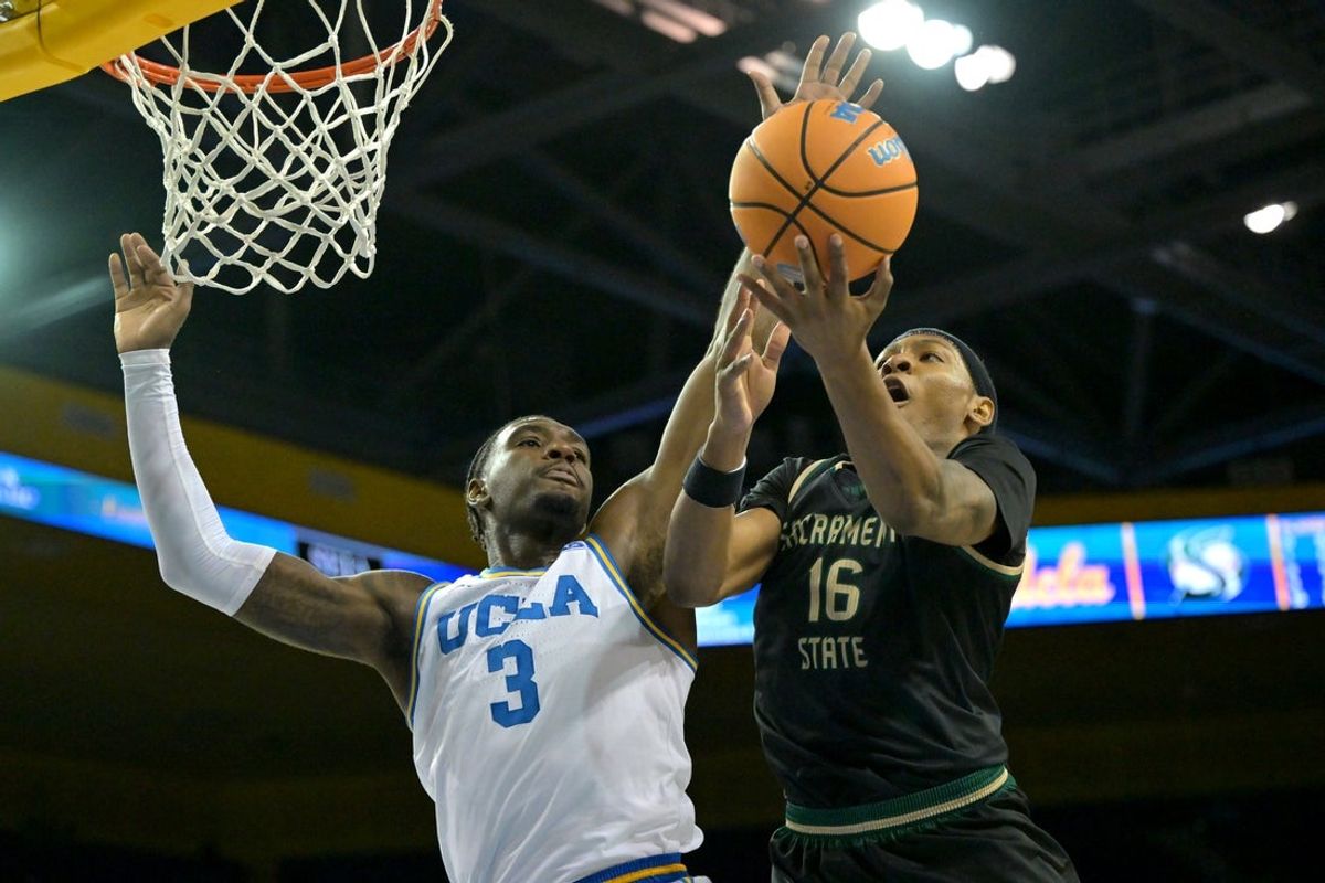 Nov 18, 2025; Los Angeles, California, USA;  UCLA Bruins forward Eric Dailey Jr. (3) stops a shot by Sacramento State Hornets guard Prophet Johnson (16) during the first half at Pauley Pavilion presented by Wescom Financial. Mandatory Credit: Jayne Kamin-Oncea-Imagn Images